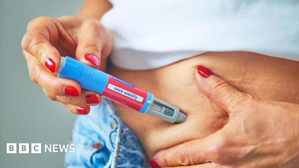 A woman injects herself with the medication into the skin of her belly