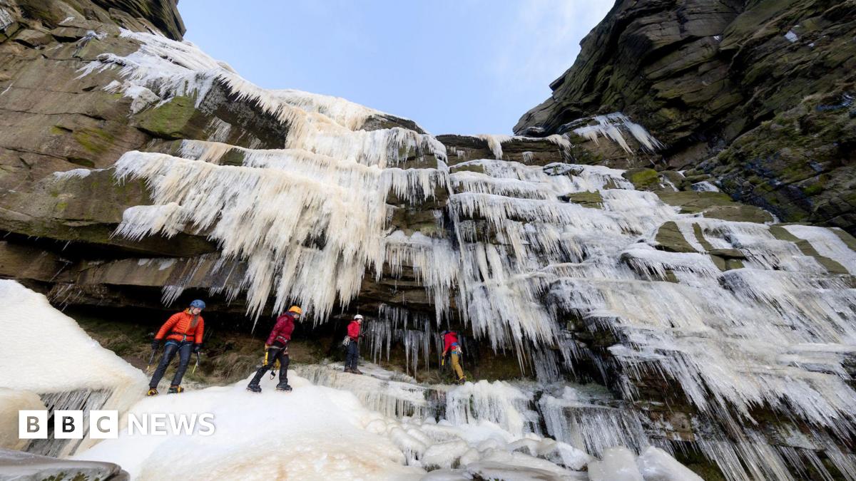 A group of ice climbers stood below Kinder Downfall, which is a waterfall that has frozen over