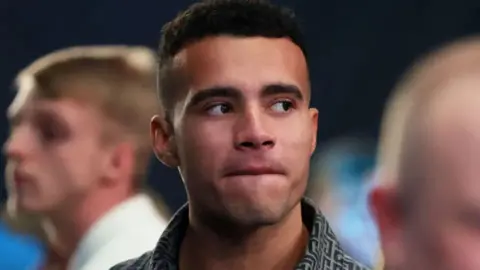 Getty Images Close up of young man looking to the side with serious face