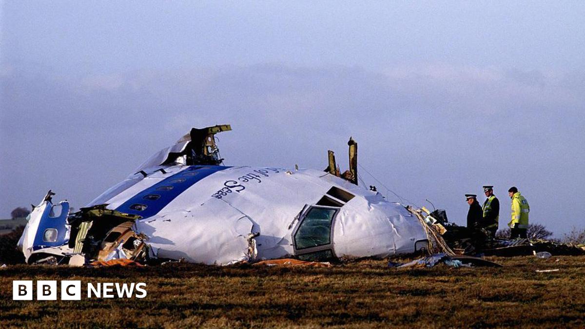The wreckage of flight Pam Am 103 in Lockerbie. Police officers inspect the area around the nose of the aircraft.