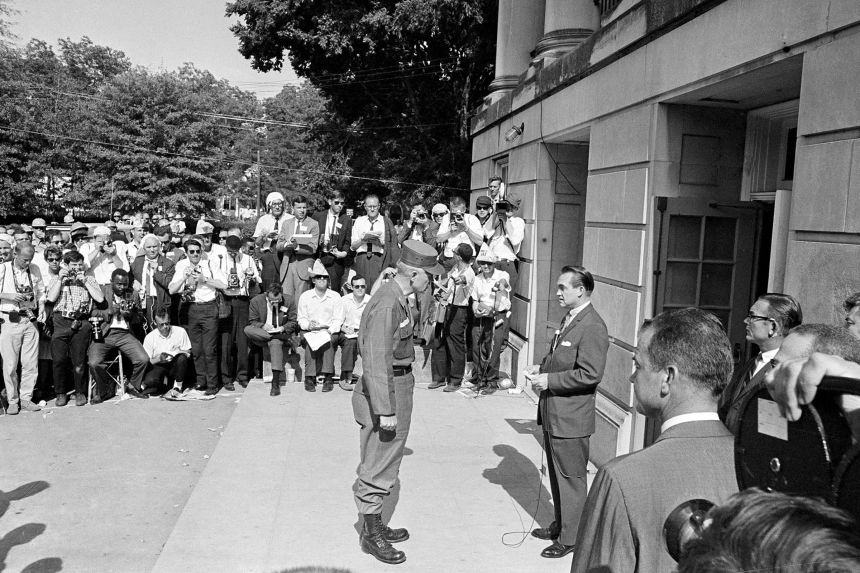 National Guard Brig. Gen. Henry Graham informs Alabama Gov. George Wallace, right, that the guard is under federal control as the two meet at the door of Foster Auditorium at the University of Alabama in Tuscaloosa, Alabama, on June 11, 1963.