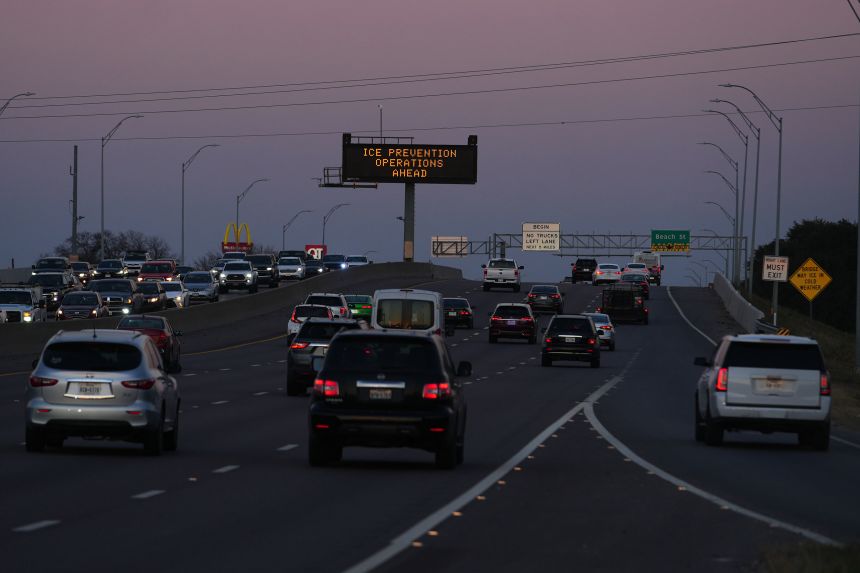 A sign above Highway 121 in Fort Worth, Texas, warns of road preparations ahead of the storm on Wednesday, January 21.