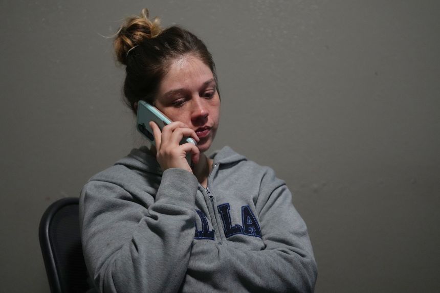 Cheyenne Hangaman speaks on the phone to a supporter Tuesday, the day after three of her sons died after falling into an icy pond in Bonham, Texas.
