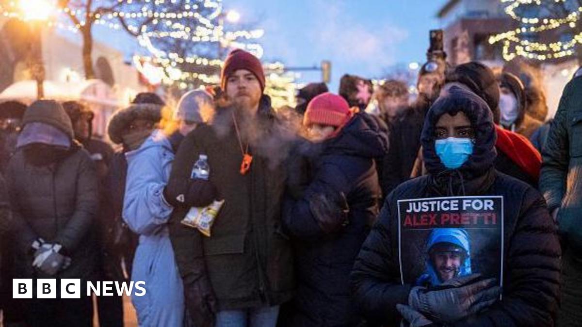 People mourn at a memorial in the area where 37-year-old Alex Pretti was shot dead by federal immigration agents earlier in the day in Minneapolis, Minnesota, on January 24, 2026.