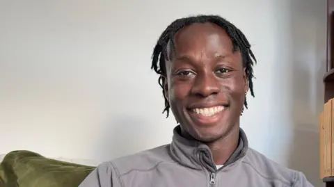 David Larbi Head and shoulders image of David Larbi smiling, wearing casual zip up top.