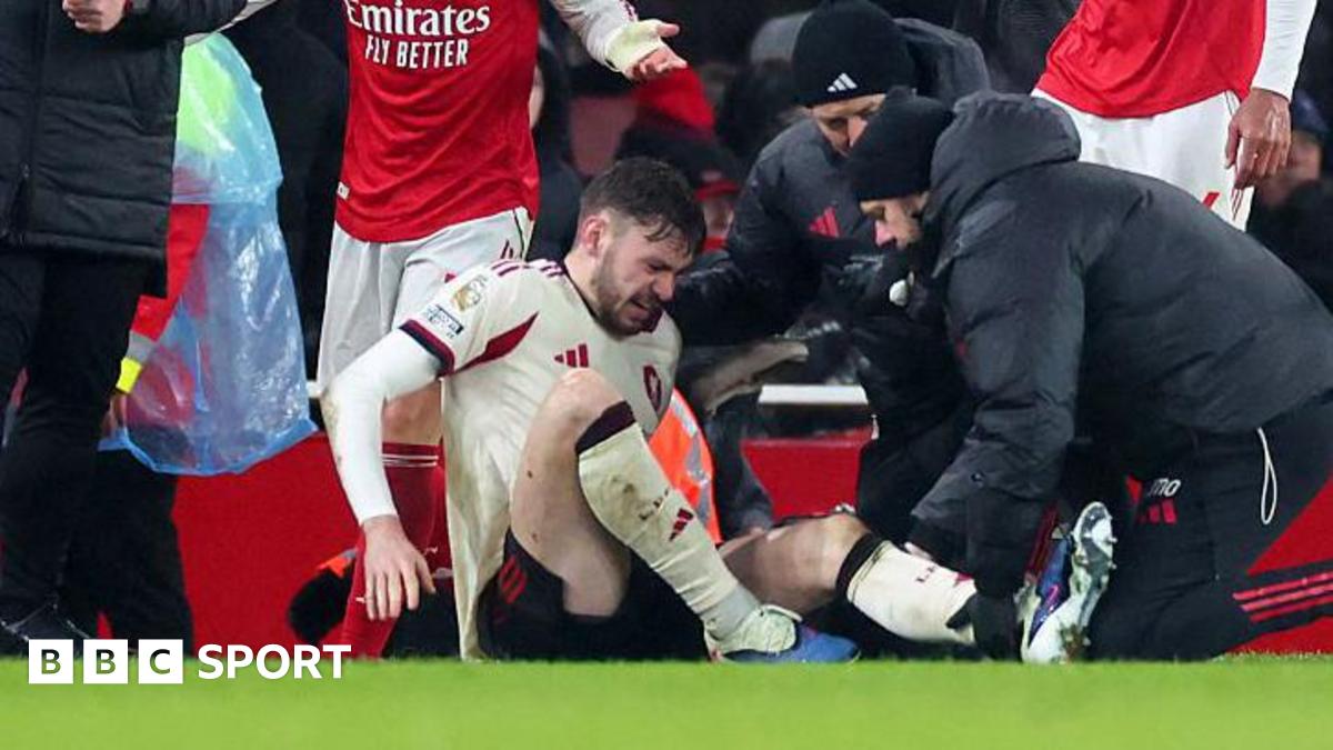 Liverpool defender Conor Bradley is treated for injury on a football pitch