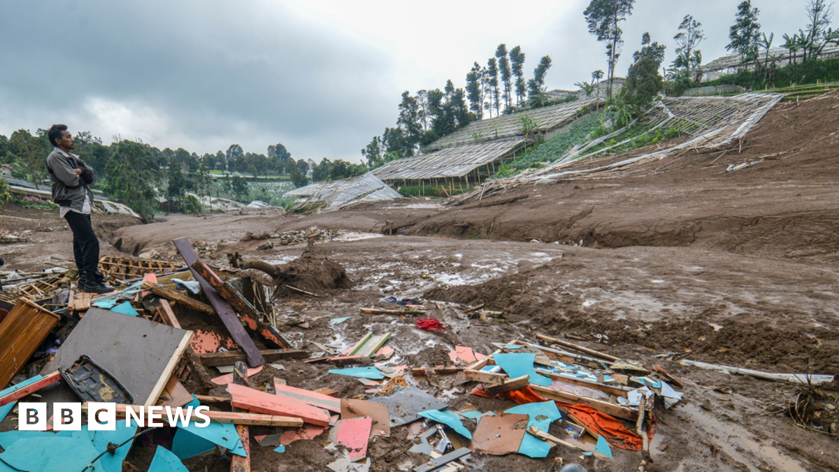 A villager stands on the debris of damaged houses after a landslide affected the area in Pasirlangu village, West Bandung, West Java Province, Indonesia, 24 January 202