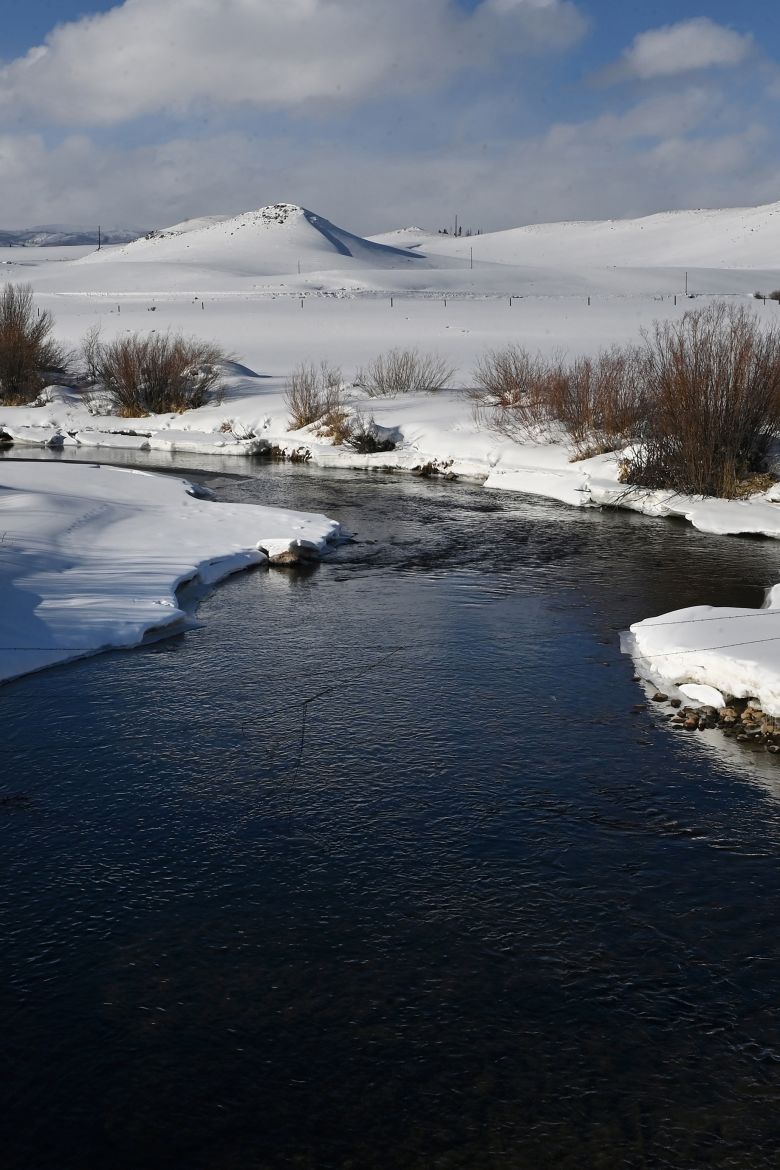The Colorado River flows through the snowy landscape of Grand County, Colorado, in February 2022.