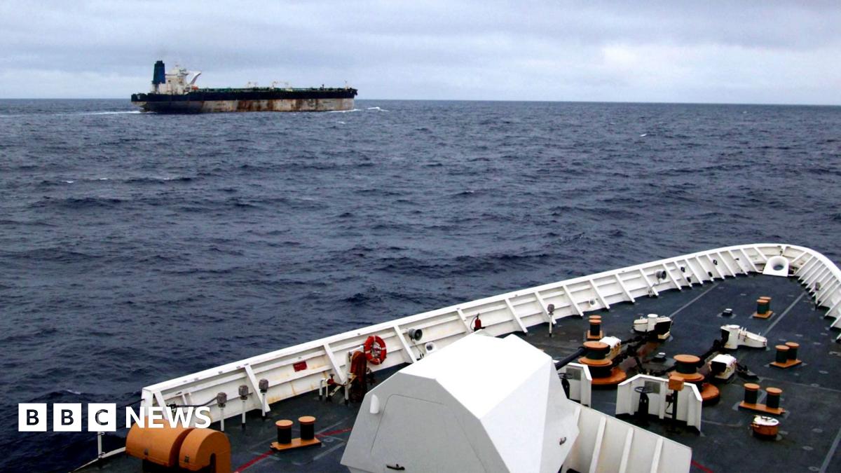 The shadow fleet ship Marinera seen in the distance from the upper decks of a US coastguard cutter following her.