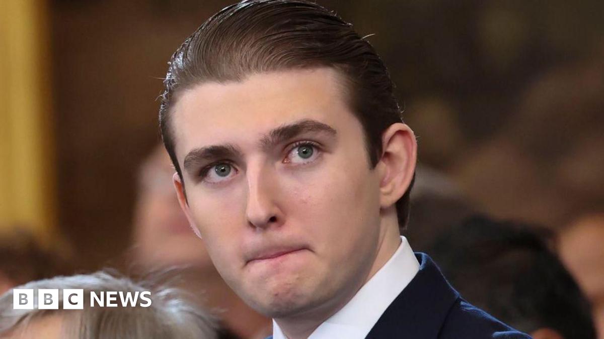 Baron Trump is pictured at his fathers inauguration in the Rotunda of the U.S. Capitol on January 20, 2025.  His hair is slicked back.