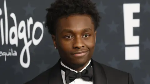 EPA Miles Caton wearing a dinner jacket and black bow tie