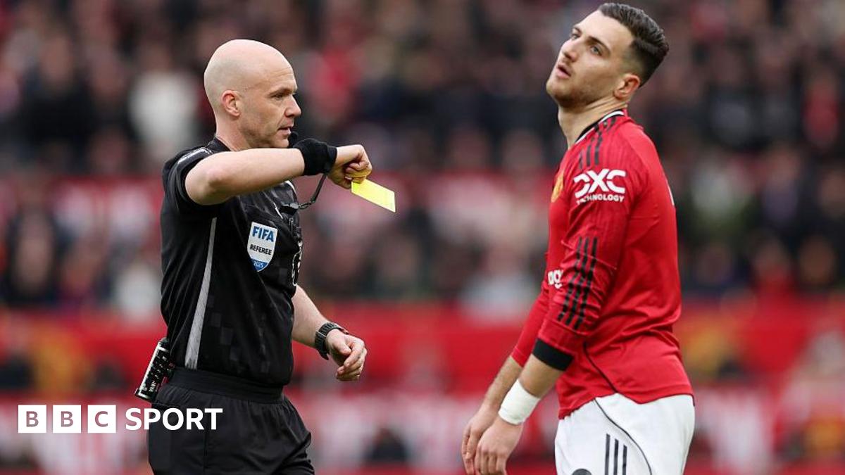 Referee Anthony Taylor shows a yellow card to Diogo Dalo