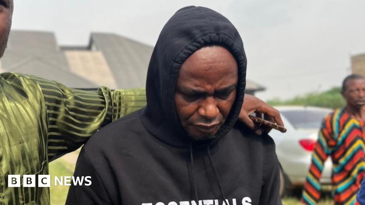 Donald Trump and Keir Starmer sit in a formal drawing room setting  on arm chairs with US and UK  flags behind them. Both have serious expressions and are looking out and not at each other.