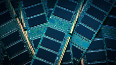 Getty Images Ram chips sacked on top of one another. They are green rectangles with black boxes, and golden marks at the bottom where they would plug in to a computer.