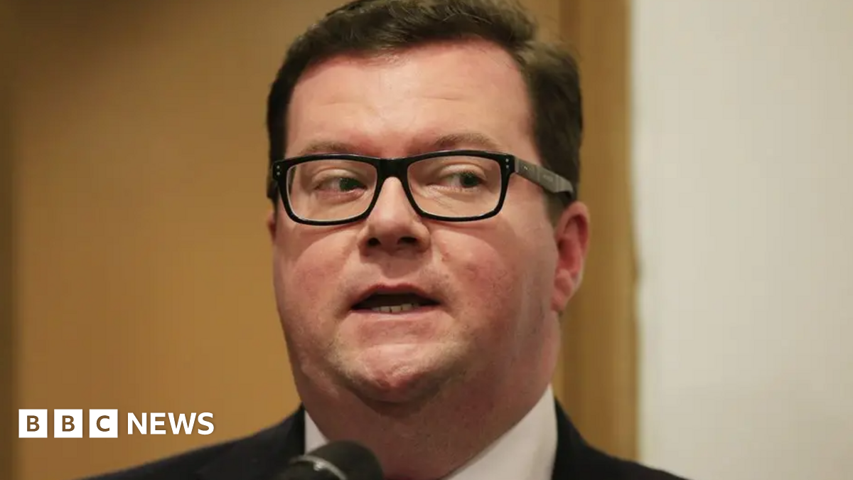 A close shot of Conor McGinn. He has short dark hair and is wearing a pair of glasses.