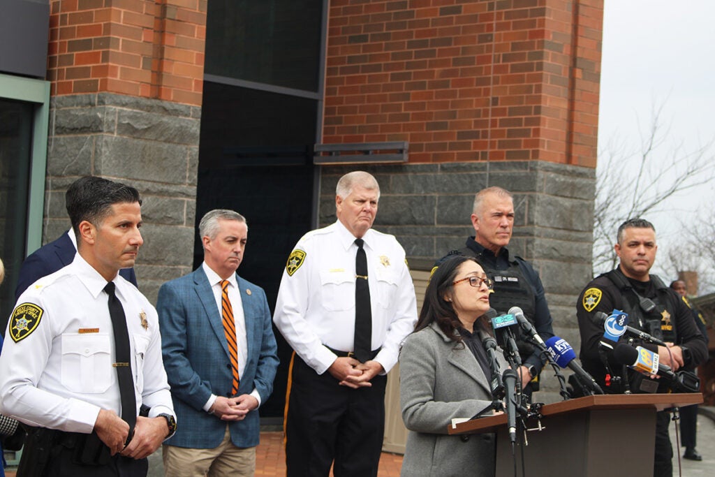 Heidi Roux, an immigrant rights activist and Bucks County resident, speaks from a podium