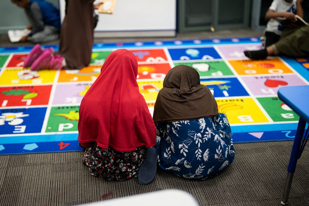 Children wearing hijabs read at ABC Learning Center Inc. in Minneapolis.