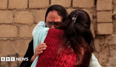 Fire fighters and rescue workers perform a cooling operation amid the debris after a massive fire at a shopping mall in Karachi on January 19, 2026
