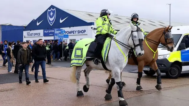 Mounted police officers are seen outside the stadium prior to the Championship match between Portsmouth and Southampton at Fratton Park