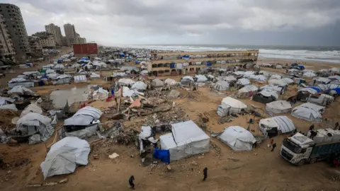 Reuters Tents used by displaced people on a beach during a windy winter day in Gaza City, northern Gaza (13 January 2026)