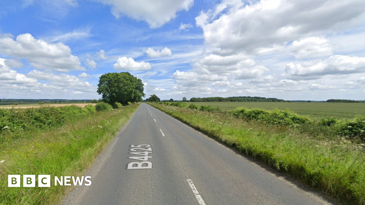 Google image of a strip of the B4425. It is a long, straight stretch of road with fields and hedges to either side of the carriageway. Google's 'B4425' text is shown on the road.