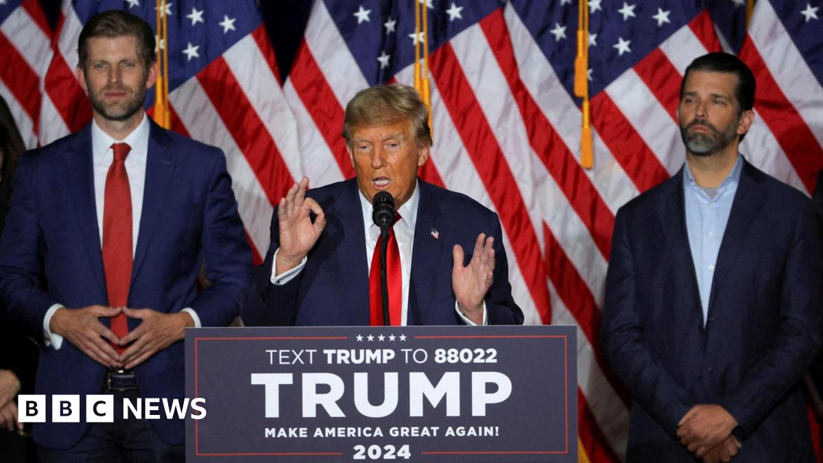Republican presidential candidate and US President Donald Trump speaks accompanied by his sons Eric Trump and Donald Trump Jr  during his caucus night watch party in Des Moines, Iowa, 15 January 2024