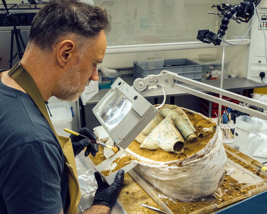 Jonathan Clark, a senior conservator at Norfolk Museums Service, conducts a micro-excavation of the hoard.