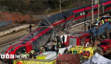 Responders and emergency workers surround the derailed train with ambulances and personnel in a wide shot taken on Monday.