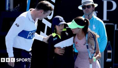 Turkey's Zeynep Sonmez assists a ball kid after she fainted during Sonmez's women's singles match against Russia's Ekaterina Alexandrova