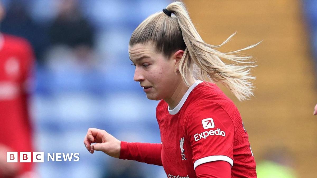 Donald Trump and Keir Starmer sit in a formal drawing room setting  on arm chairs with US and UK  flags behind them. Both have serious expressions and are looking out and not at each other.