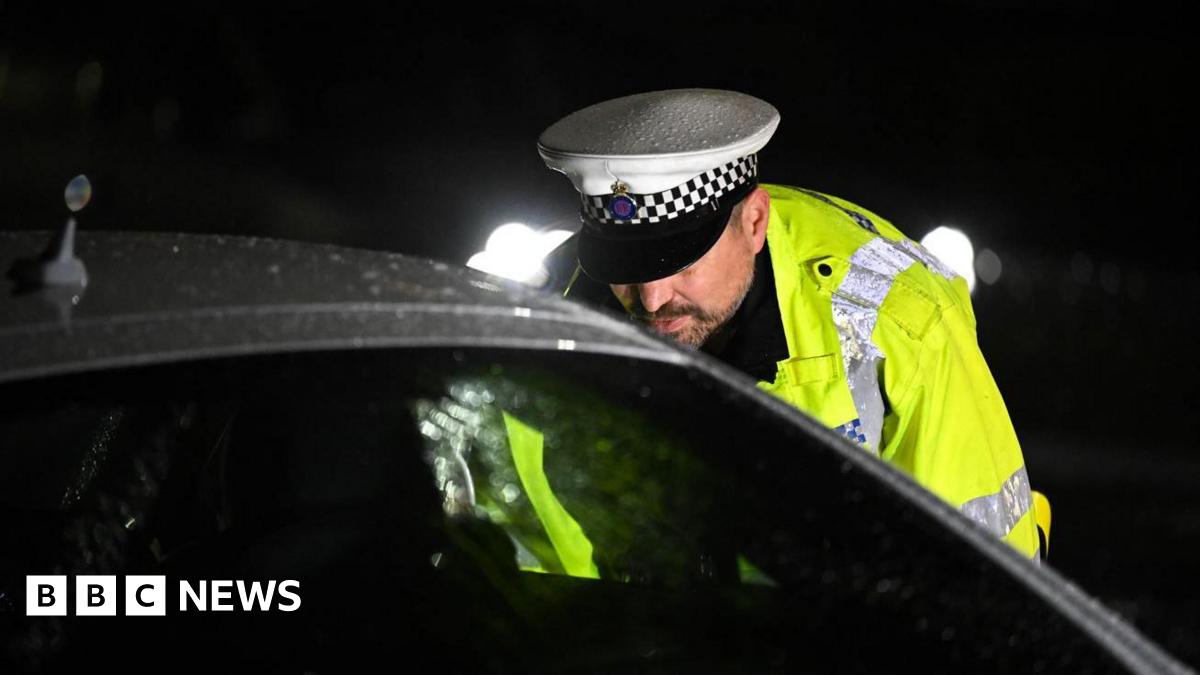 A police officer speak to a drug driver