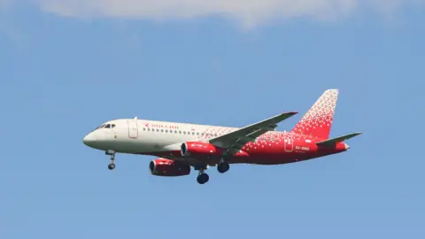 LightRocket via Getty Images The white and red coloured Rossiya Sukhoi Superjet 100 aircraft is preparing to land at Pulkovo Airport in St. Petersburg, in the Russian Federation