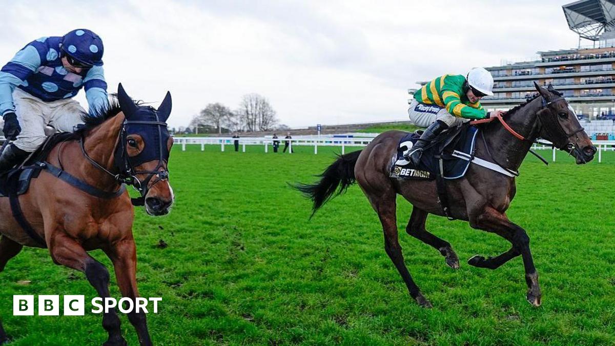 Jonbon and Thistle Ask clear the last fence and race towards the line. Jonbon's jockey, James Bowen, is wearing a white cap and a green-and-gold top. Thistle Ask is being ridden by Harry Skelton, who has a blue cap and top with lighter blue dots.