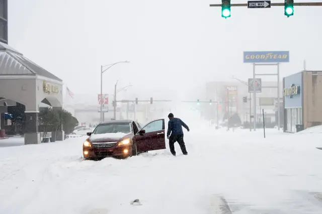 A man's car is stuck in the snow in Arkansas
