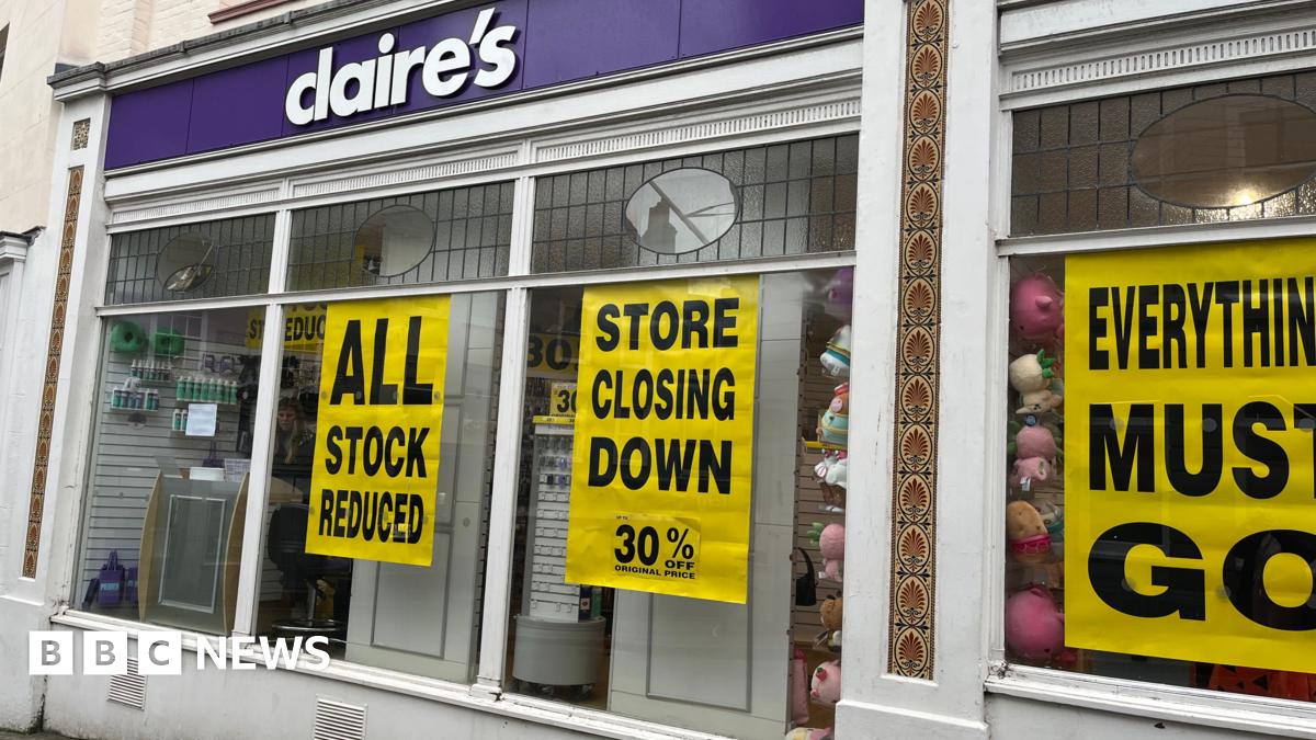 The front of a Claire's store with signs promoting a closing-down sale with slogans such as 'everything must go'