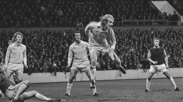 Terry Yorath (centre front) and Paul Madeley (1944 - 2018, centre back) of Leeds United during a League Division One match against West Ham United at Upton Park in London, UK, 7th December 1974. The score was 2-1 to West Ham.