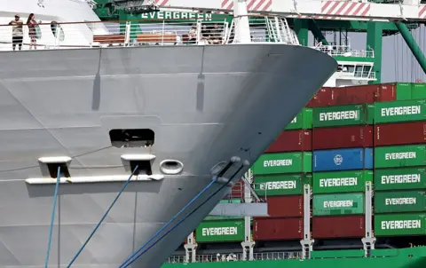 Getty Images Evergreen container ship loaded with shipping containers (R) at the Port of Los Angeles on September 26, 2025 in Los Angeles, California. 