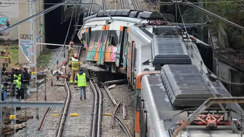 NurPhoto via Getty Images A train derails in Gelida, Spain, on January 21, 2026, after colliding with a retaining wall that fell on to the track due to heavy rain