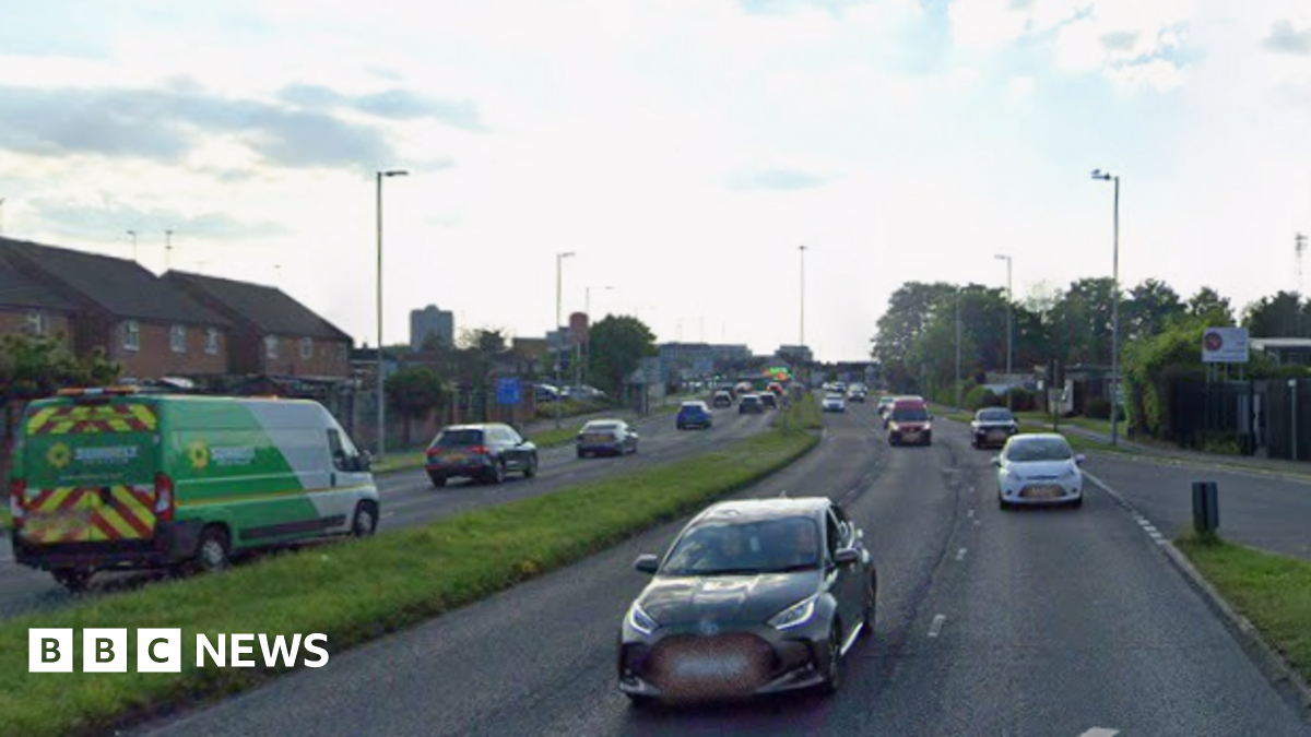 A google streetview image of the road, showing cars driving along it