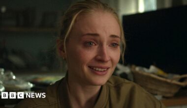 Woman being comforted at site of Gul plaza fire