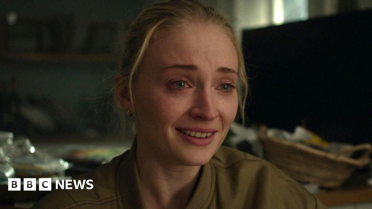 Woman being comforted at site of Gul plaza fire