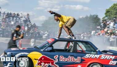 A woman looking at her mobile phone and the graphic BBC News Africa