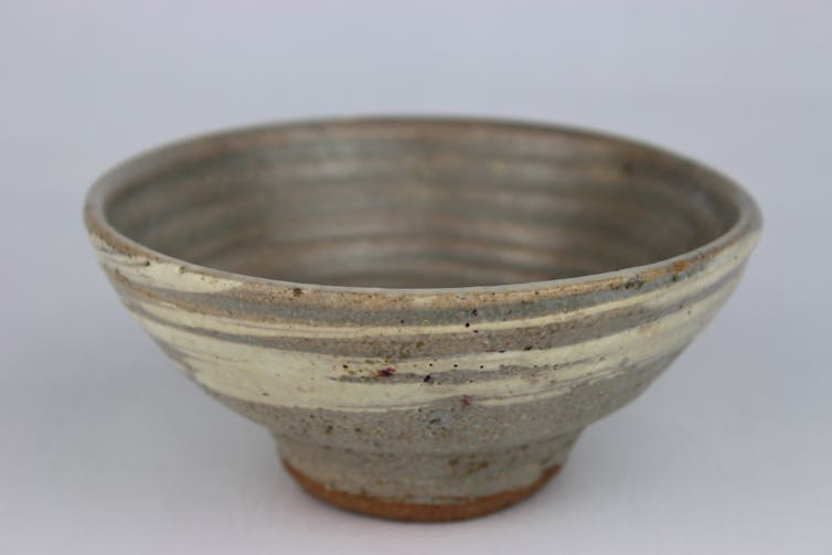 Close-up shot of a grey-ish hand-made bowl.