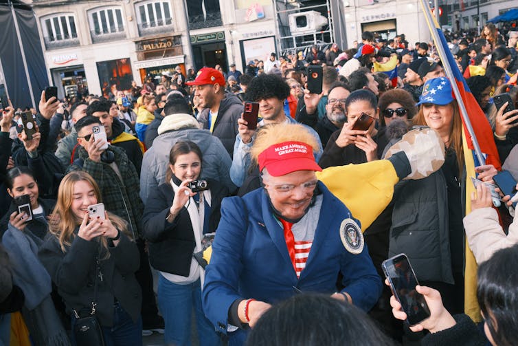 A woman dressed as Donald Trump during celebrations in a public square in Madrid.
