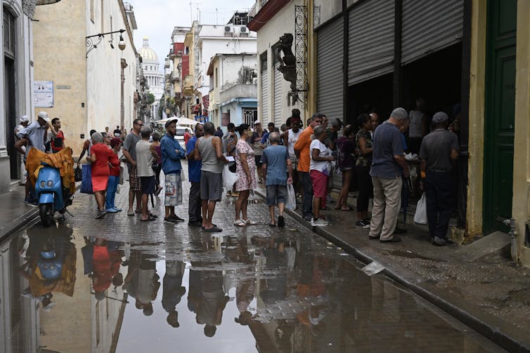 A group of people stand on the street
