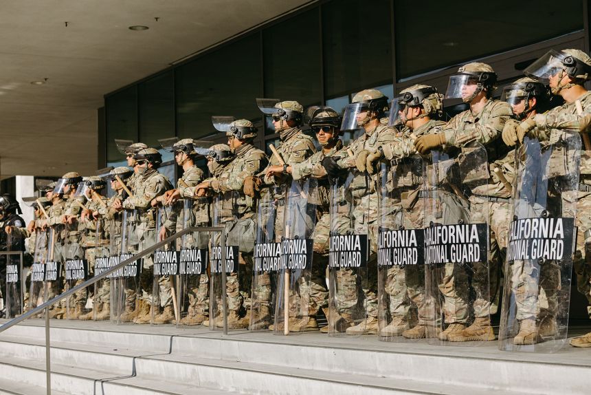 Members of the California National Guard stand guard outside the Federal Building before a curfew takes effect in Los Angeles on June 10, 2025.