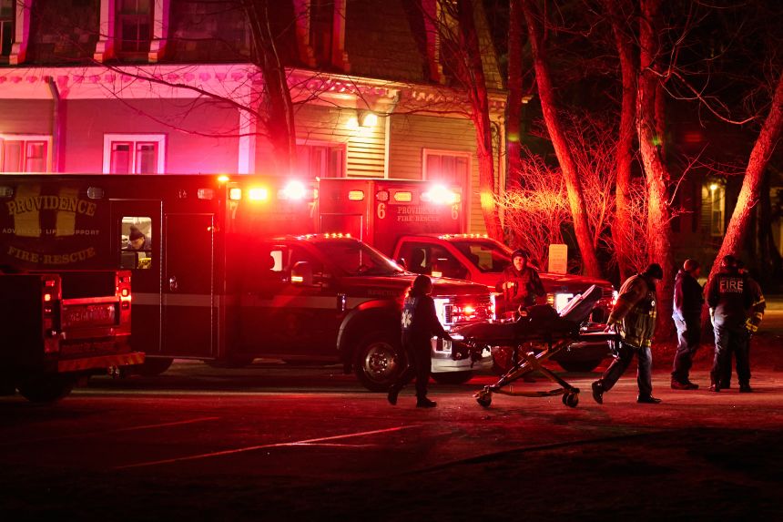 Providence Fire Department personnel maneuver an empty stretcher December 13 near the Barus & Holley building at Brown University in Providence, Rhode Island.