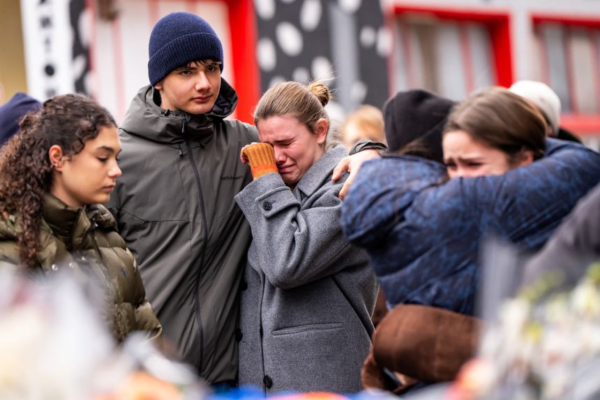 Mourners gather near the site of a fire that ripped through a bar during New Year's Eve celebrations in the Alpine ski resort town of Crans-Montana killing around 40 people and injuring more than 100 others, in Crans-Montana on January 2, 2026.
