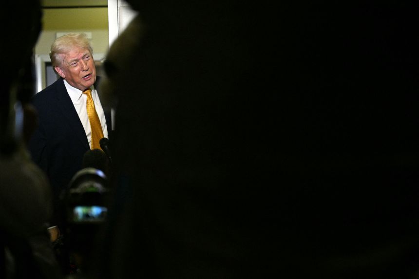 President Donald Trump speaks with reporters aboard Air Force One on his way back to Washington, DC, on January 4, 2026.