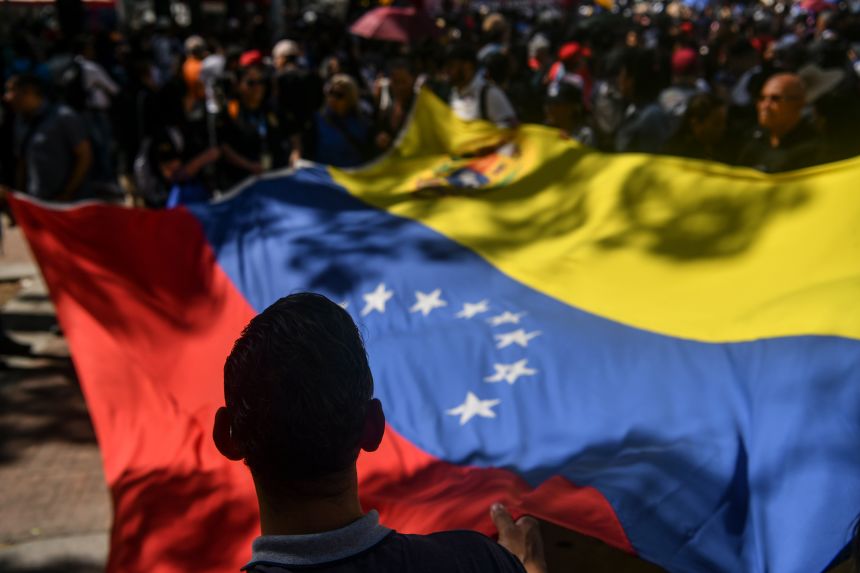 Government supporters wave a Venezuelan flag during a demonstration on January 8, 2026 in Caracas, Venezuela.